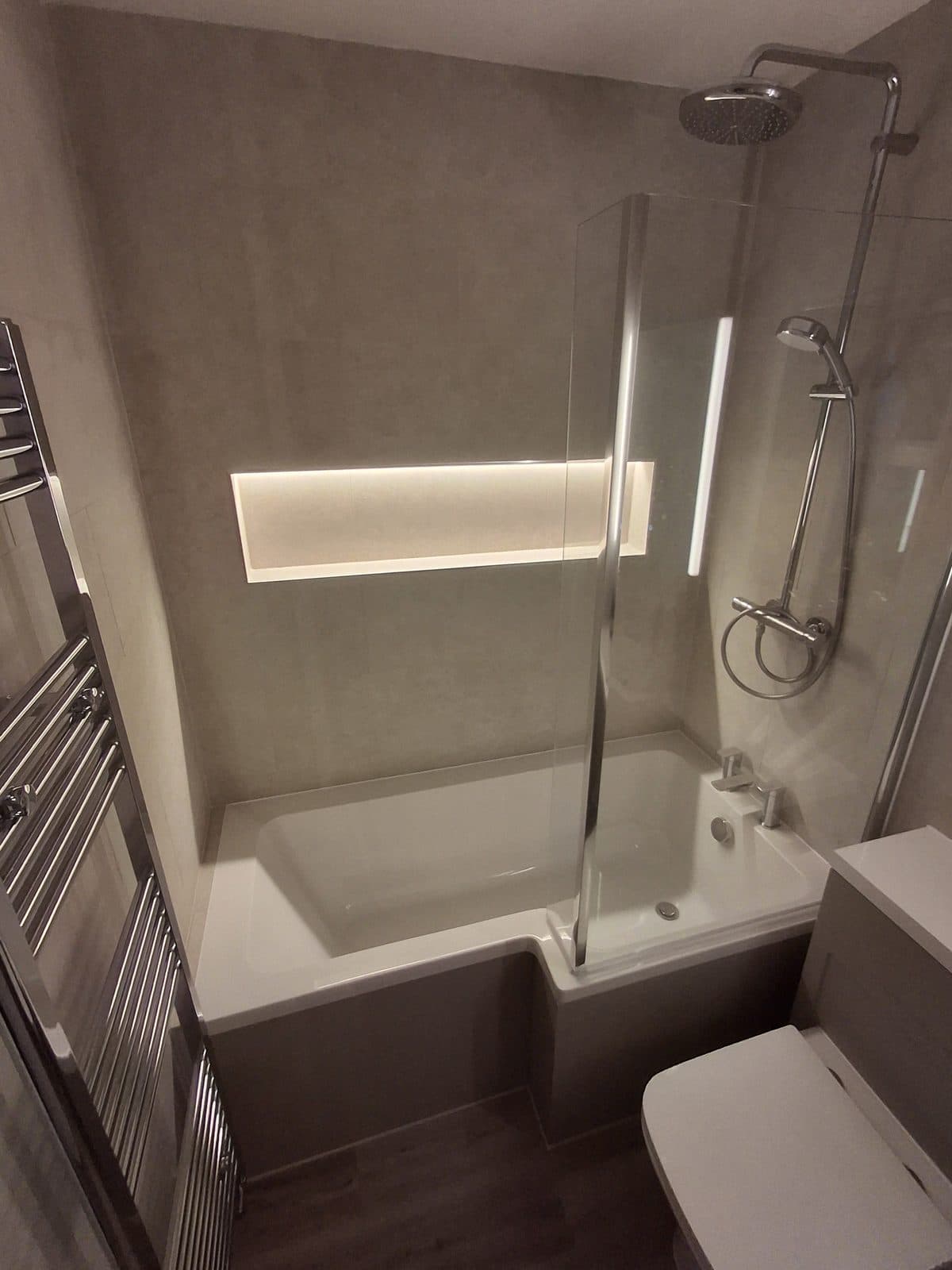 Bathroom with LED-lit shelf and heated towel rail fitted by HOC Home Improvements