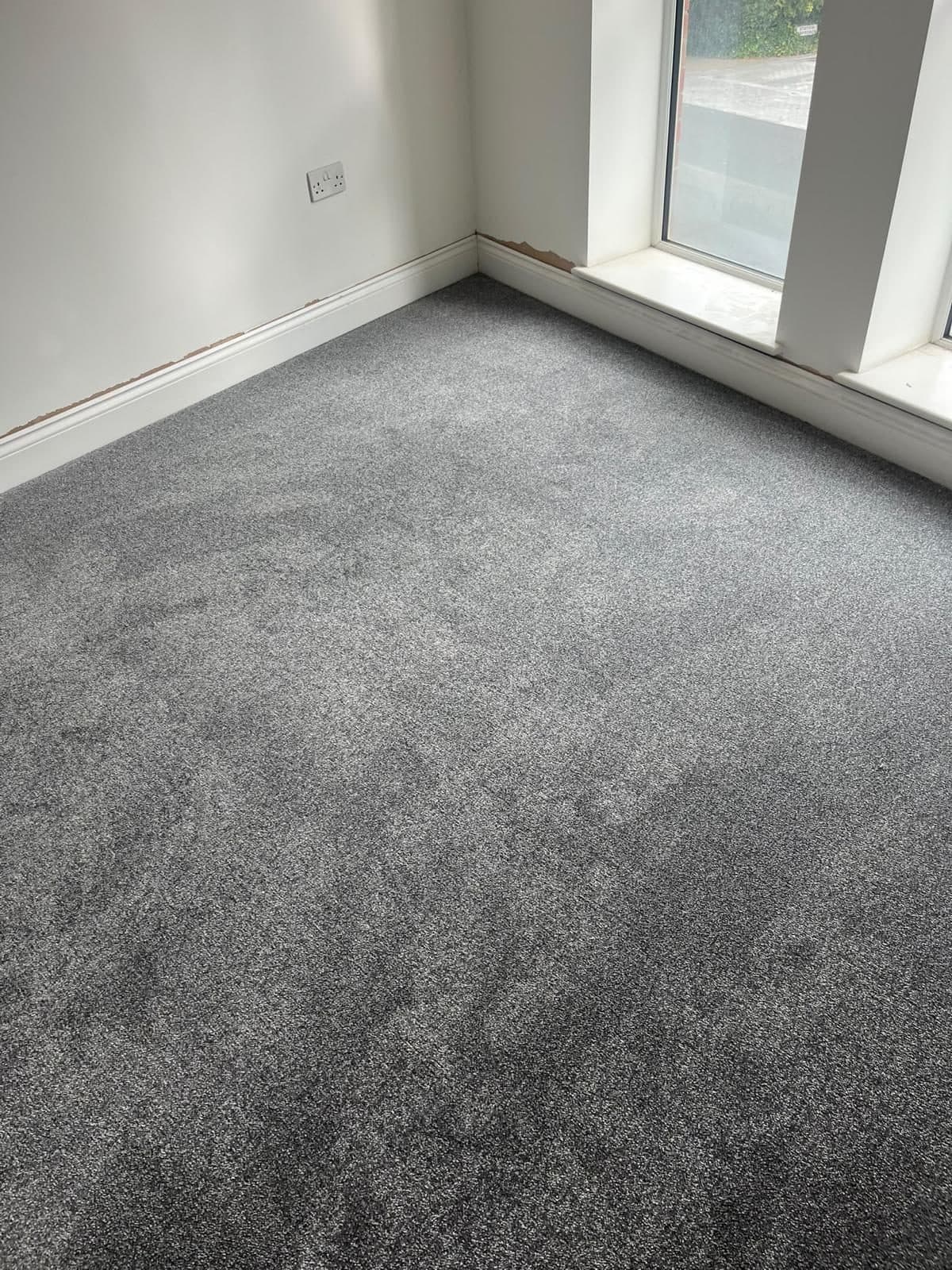 Grey carpet fitted in a living room by HOC Home Improvements in Surrey